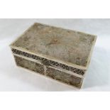 A rectangular Chinese silver coloured metal filigree cigarette box, with wooden interior,