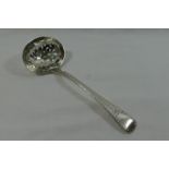 A George III old English pattern sifter spoon with bright cut engraved decoration,