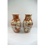 A pair of Japanese Kutani porcelain vases, decorated with birds amongst flowers,