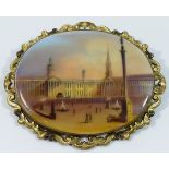 A Victorian oval porcelain brooch, hand painted with a scene of Trafalgar Square, London,