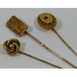 Three Victorian gold stick pins with knot, aesthetic bird and garnet set tops, combined weight 8.