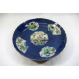 A Chinese famille vert blue ground dish, the centre panel decorated with shellfish,