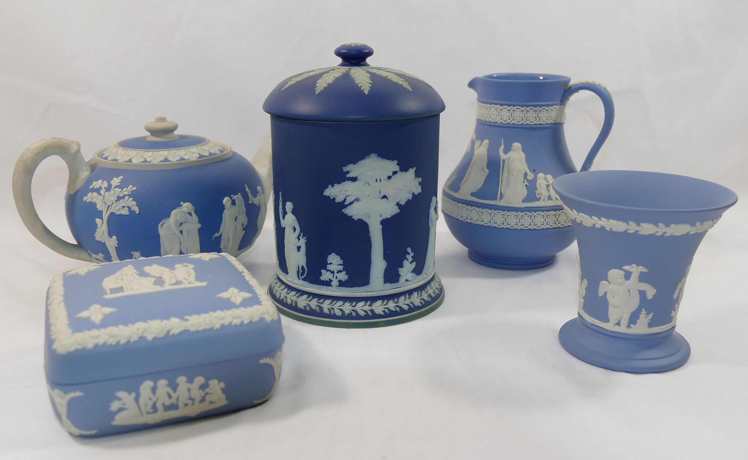 A collection of four Wedgwood blue jasperware items comprised of a tabacco jar, 15.