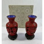 A pair of small red cinnabar lacquer vases, pierced and carved with floral panels,