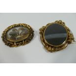 A Victorian hollow gold and black enamel oval mourning brooch,