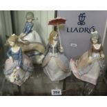 Lladro, four figures including lady with dog and three figurines with parasols (1 box).