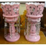 Pair of Victorian pink glass table lustres with enamel decoration, height 33cm.