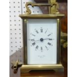 A modern brass cased carriage clock with platform escapement and key.
