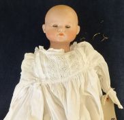 An Armand Marseille / Simon and Halbig bisque head doll (head detached), with straw filled body,