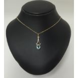 A 9ct gold pendant set with a blue zircon on fine chain.