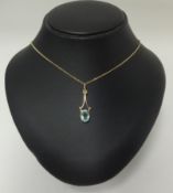 A 9ct gold pendant set with a blue zircon on fine chain.