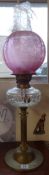 A traditional oil lamp with glass globe shade.