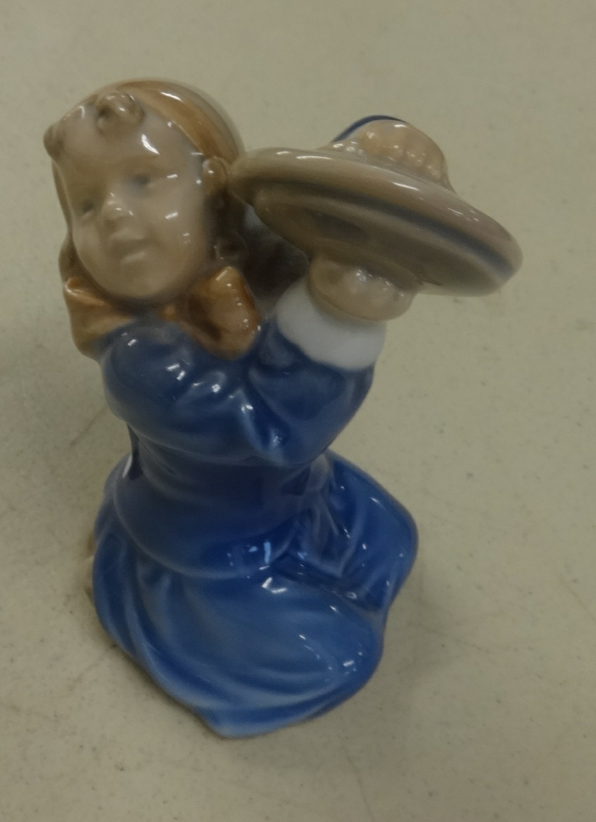 A Royal Copenhagen figure, a kneeling girl with symbols, height 10cm.