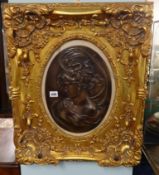 A reproduction decorative bronze affect plaque in ornate gilt frame, overall size 63cm x 53cm.