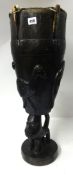 West African carved wood floor drum, height 70cm.