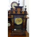 A 19th century German architectural oak case mantle clock with key and pendulum.