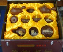 Chinese modern terracotta tea service in fitted and silk lined case, boxed.