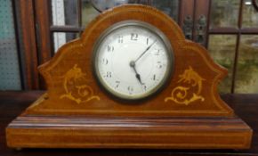 A small French mantle clock with inlaid mahogany case.