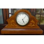 A small French mantle clock with inlaid mahogany case.