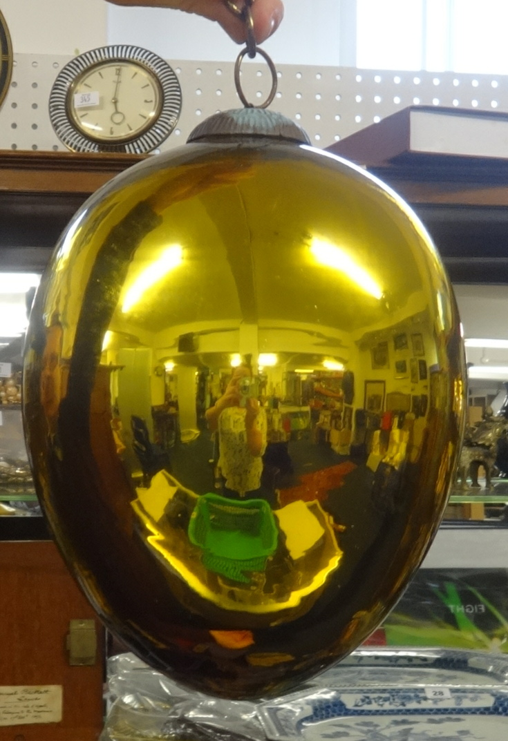 A glass 'witches' ball in gold.