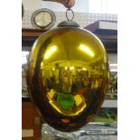 A glass 'witches' ball in gold.