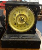 19th Century painted iron mantel clock with gilt dial and Arabic numerals, with key.