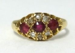 An 18ct gold ruby and diamond fancy cluster ring, finger size L.
