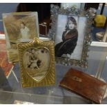 A brass easel photo frame and another, ornate pierced and metal decorative photo frame and leather