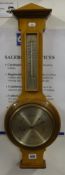 A Harrods compensated wheel barometer, in light mahogany case, height 64cm.