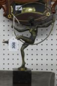 Art Deco brass sculpture of a dancing girl with hoop on black marble plinth, height 29cm.