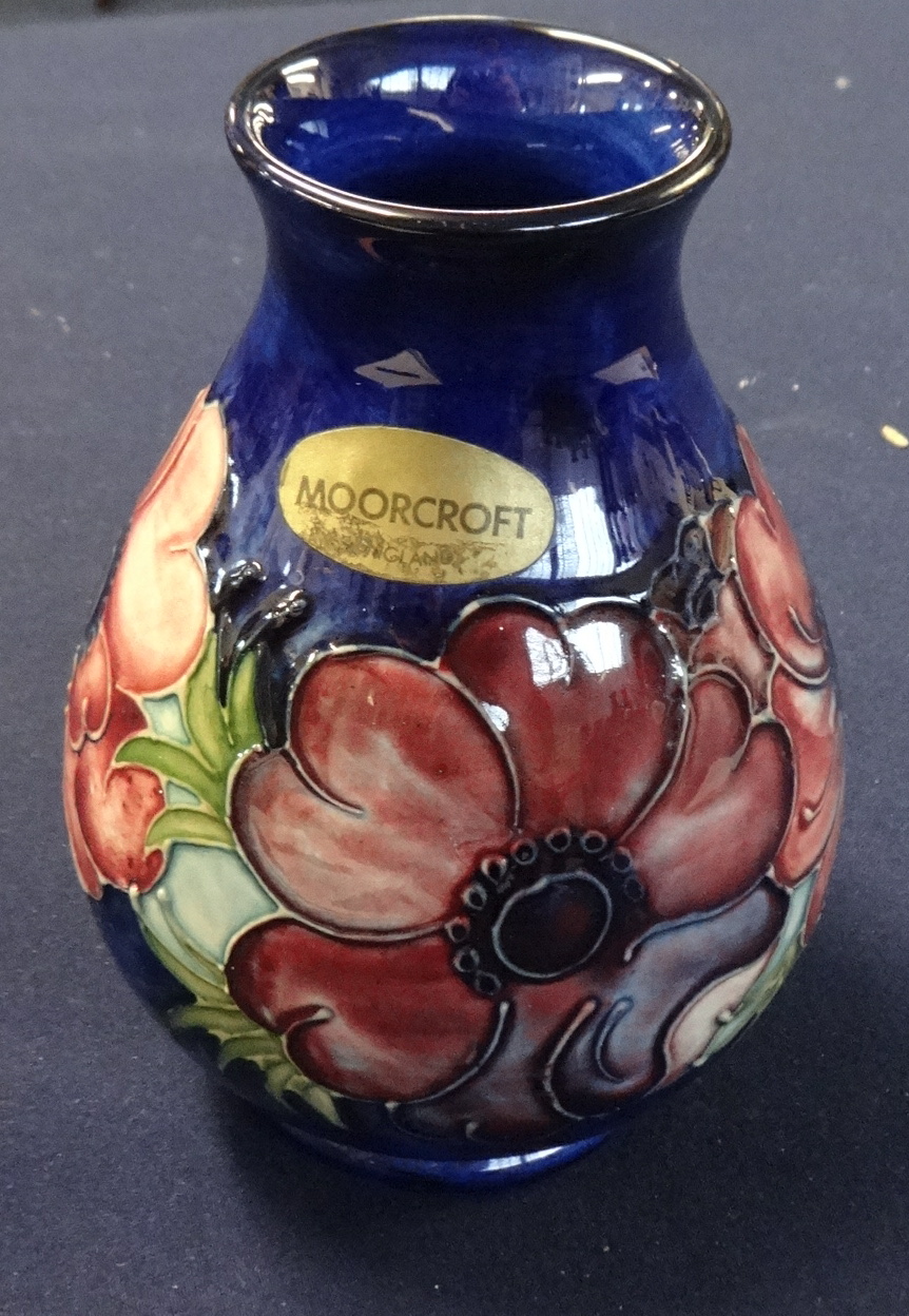 Moorcroft pottery vase decorated with anemone of baluster form, height 14cm, impressed marks.