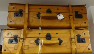 Two large tan leather suitcases, approx 75cm long with keys.