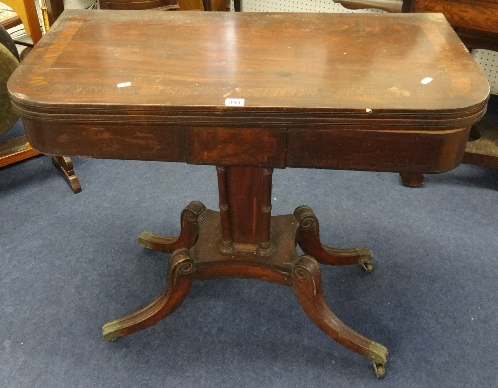 19th Century mahogany fold over card table on pedestal base.