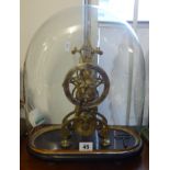 A brass skeleton clock with fussee movement, under glass dome, overall height 36cm.