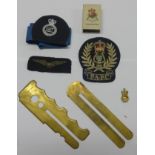 Collection of military badges, buttons, whistle and torch.