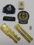 Collection of military badges, buttons, whistle and torch.