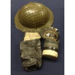 WW2 gas mask with 'tommy' helmet and cargo net.