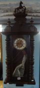 A late Victorian German spring regulator wall clock with key and pendulum.