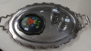 A silver plated oval serving tray with handles, a pair of modern pewter pepper grinders and a tole