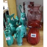 Various cranberry glass vases, turquoise pottery, animal groups and other ornaments.
