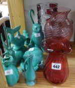 Various cranberry glass vases, turquoise pottery, animal groups and other ornaments.