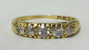 An 18ct gold, five stone ring, finger size M1/2.