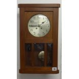 A 1920's/30's German oak wall clock strike on the gong, with key and pendulum.