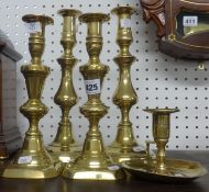 A pair of 19th Century brass baluster candlesticks, another pair and a brass chamber stick.