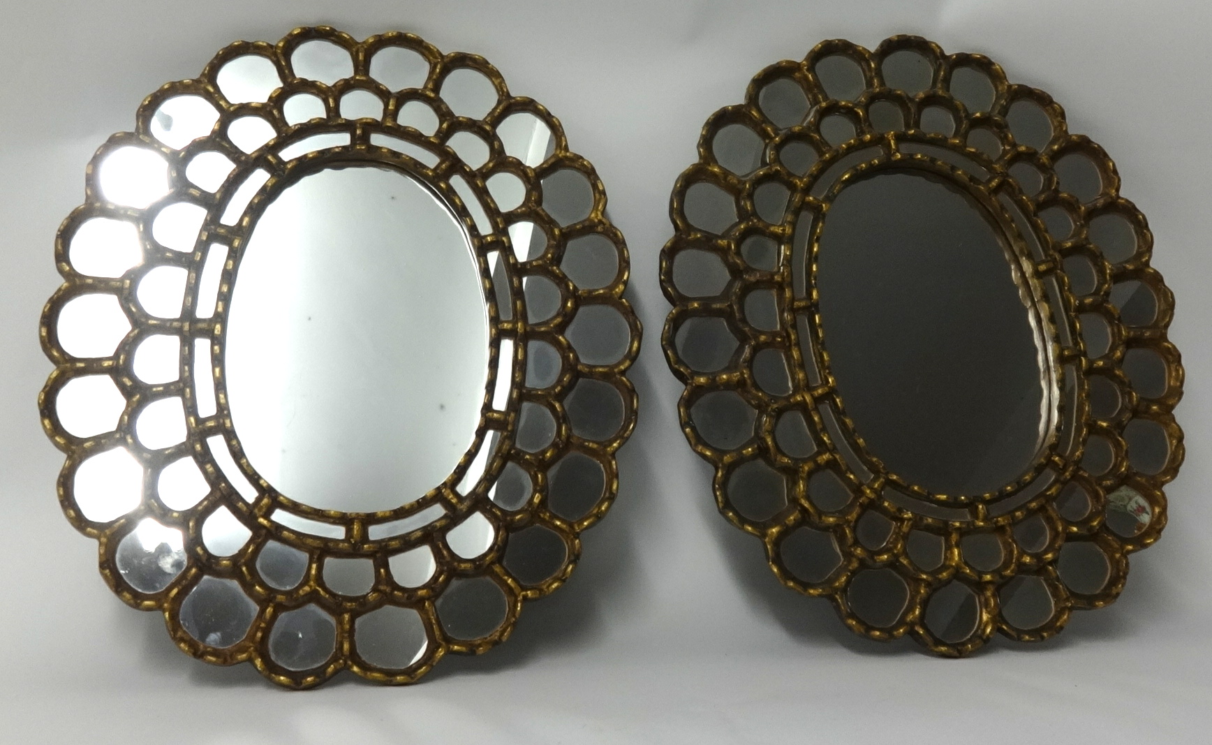 A pair of 20th Century decorative wall mirrors with gilt frames, approx 50cm x 43cm.