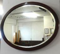 A mahogany oval wall mirror and another (2).
