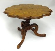 A small Victorian walnut and marquetry pedestal wine table.