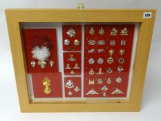 A framed collection of Military badges and buttons of various regiments, frame size 48cm x 58cm (