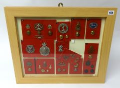 A framed collection of Military badges and buttons of various Regiments including Surrey Yeomanry