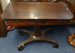A 19th Century rosewood fold over card table on pedestal base.